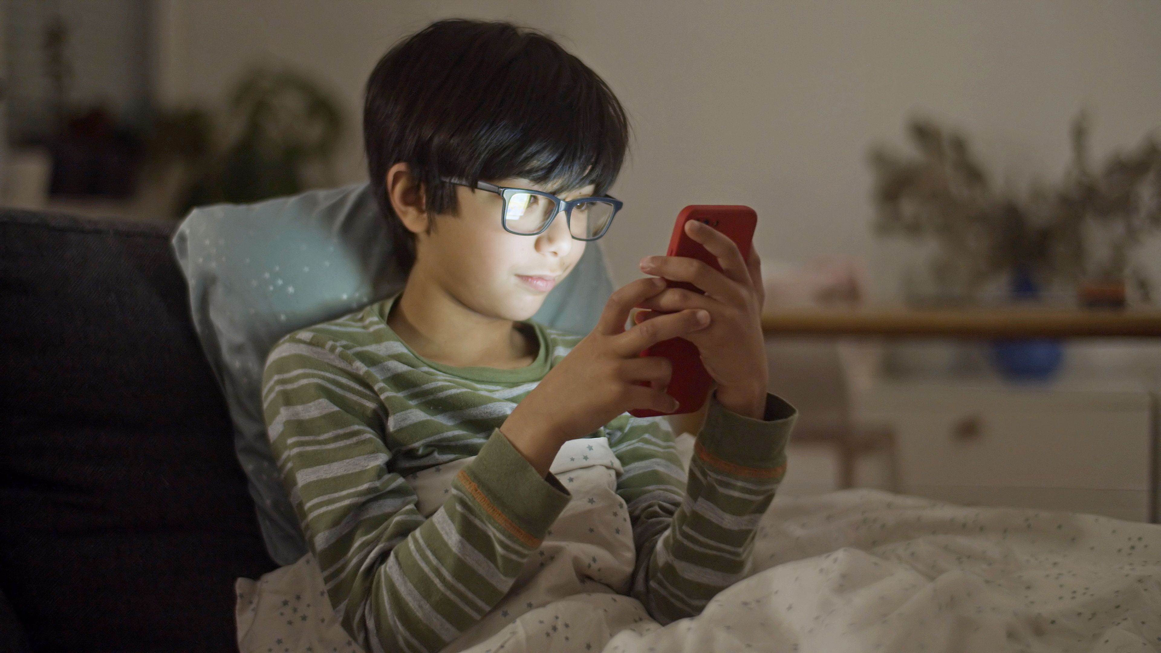 A child using a red phone at home
