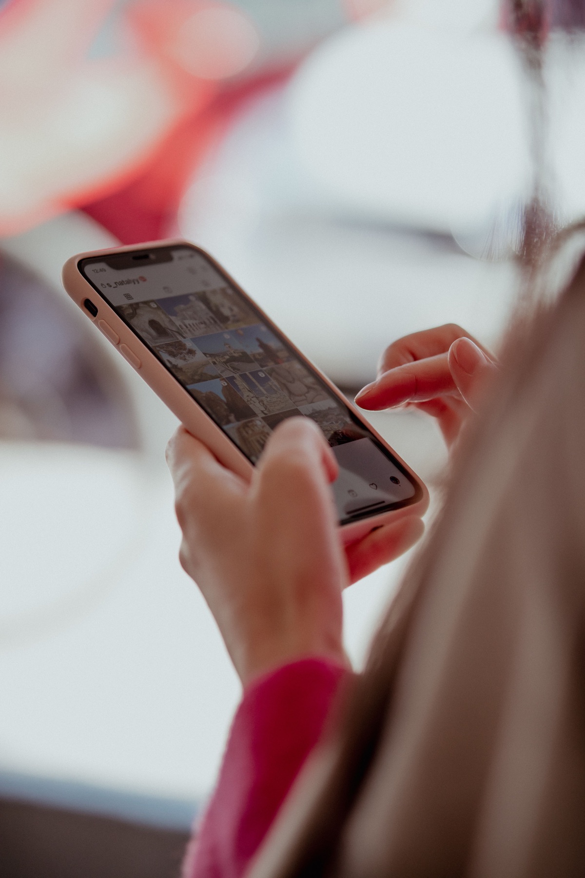 A young person scrolling through photographs on a phone