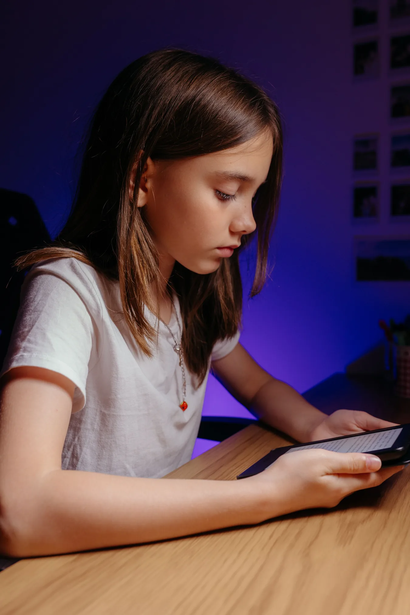 A preteen girl looking at a phone