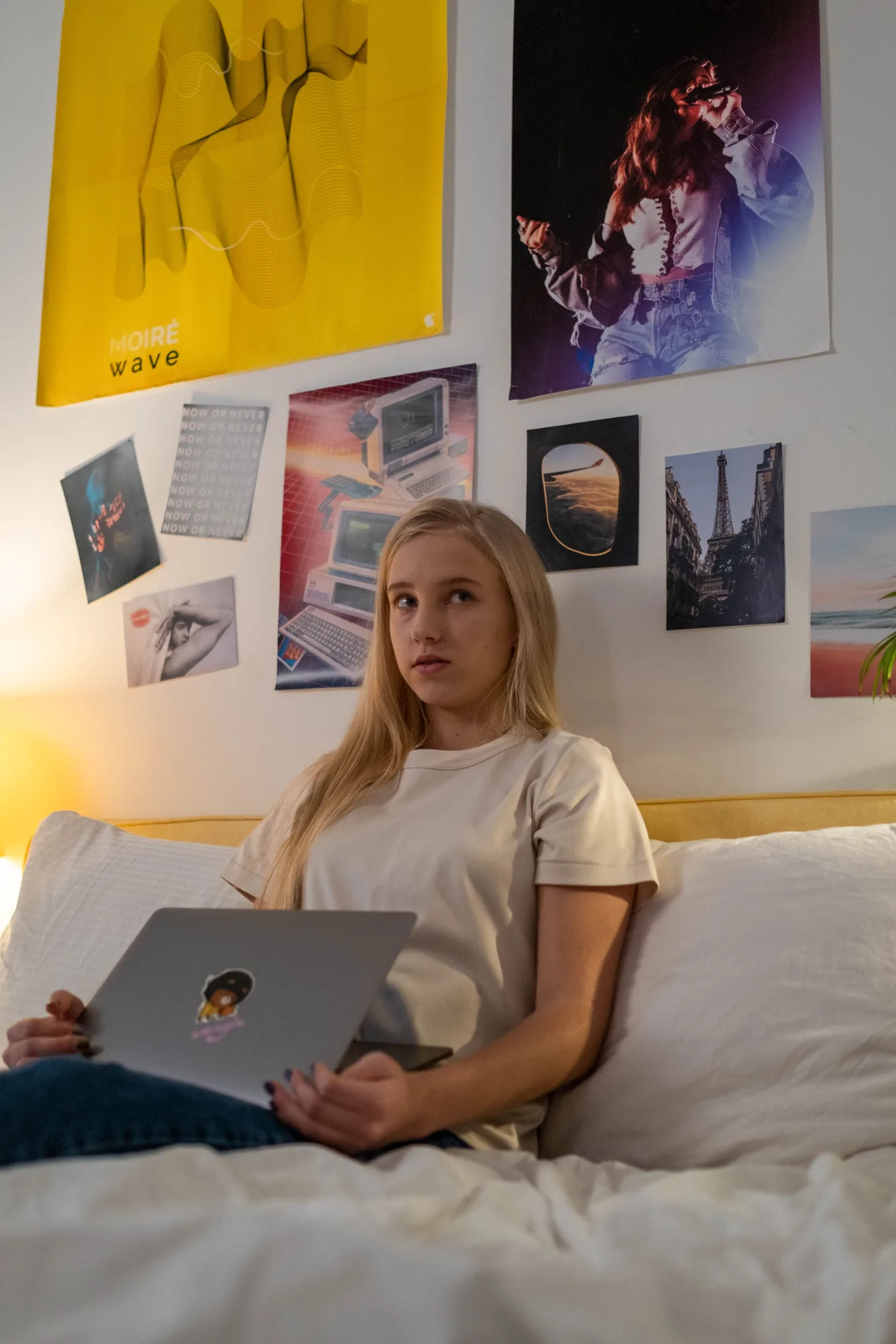 A teenage girl sitting with a laptop during a conversation