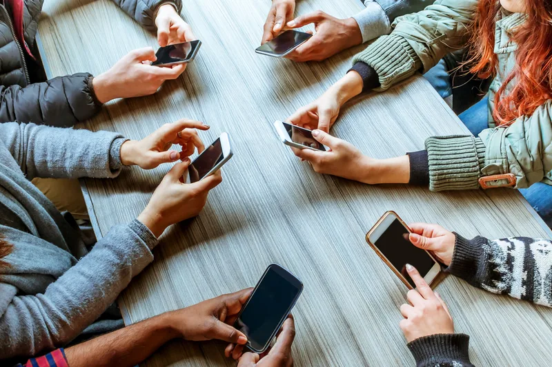People together while looking at their phones