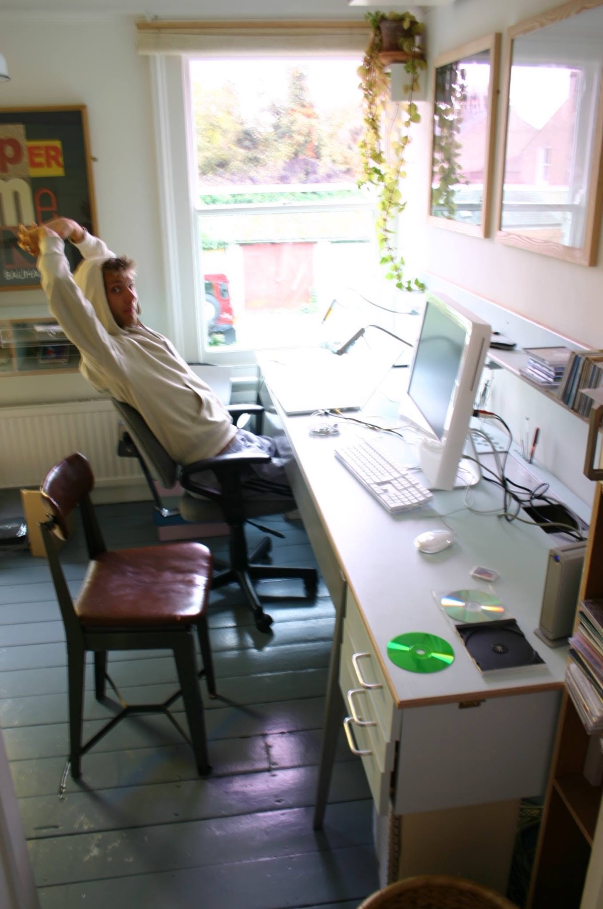 Michael Mackintosh stretching beside a desktop computer