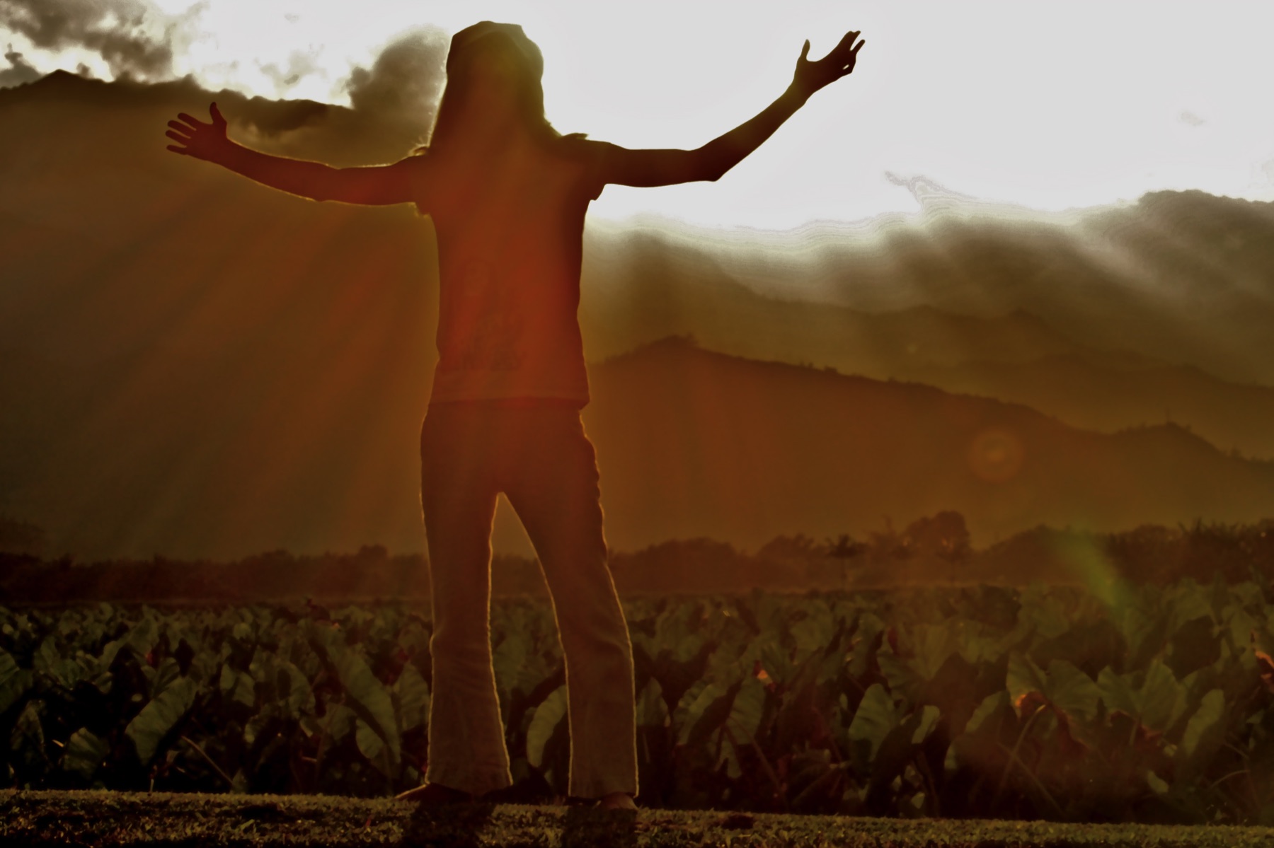 Michael Mackintosh standing with his arms open at sunrise