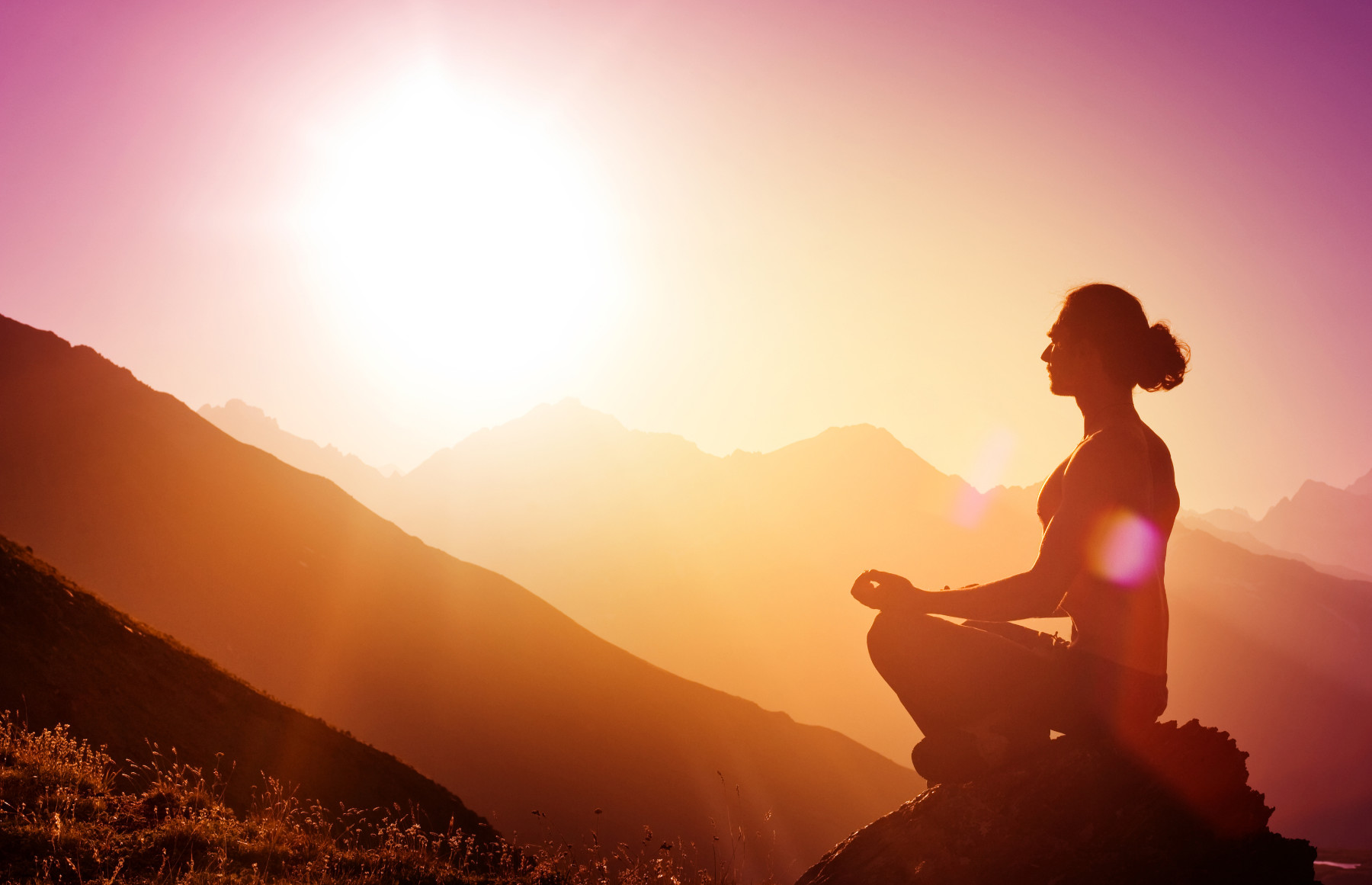 A person sitting quietly in the mountains