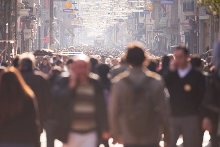 A blurred crowd of people on a street