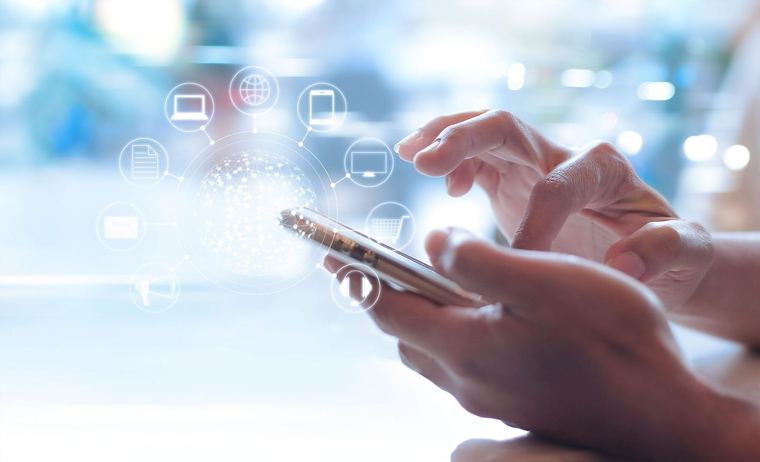 A person holding a phone surrounded by app icons