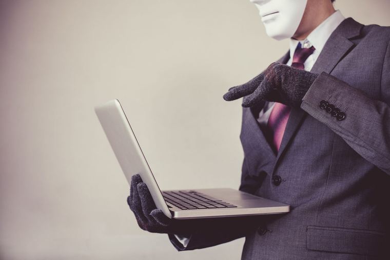 Masked man laptop
