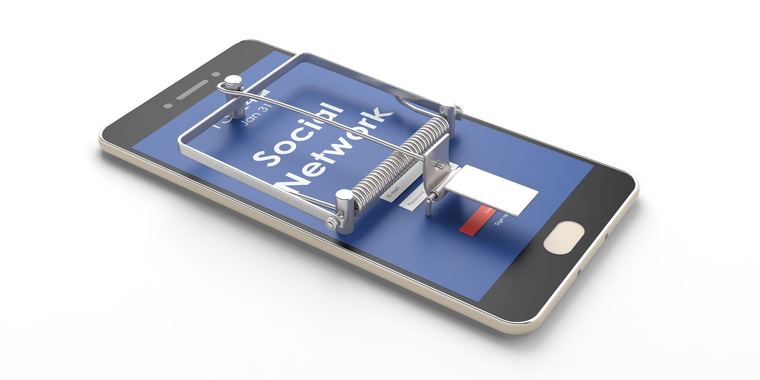 A smartphone beside a mousetrap
