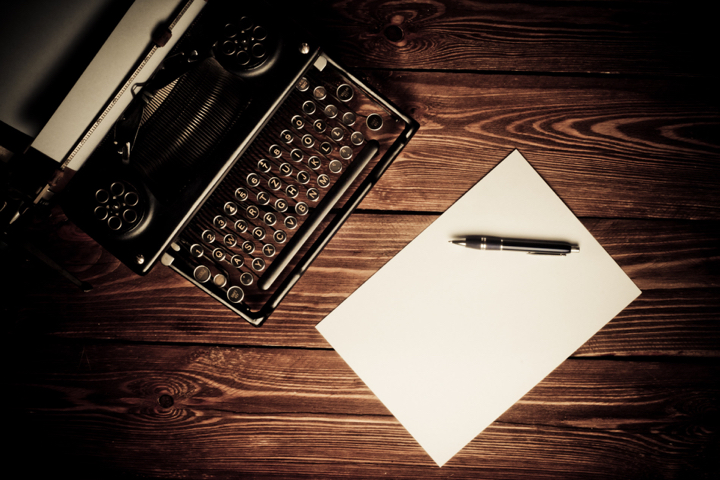 A typewriter and books
